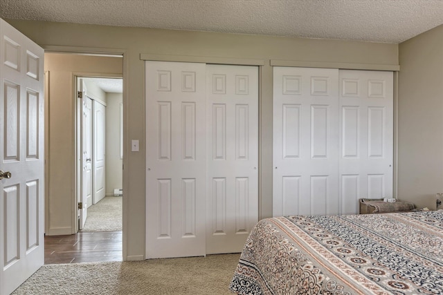 4718 N Campbell Rd, Otis Orchards, WA 99027 - bedroom with multiple closets, carpet flooring, and a textured ceiling
