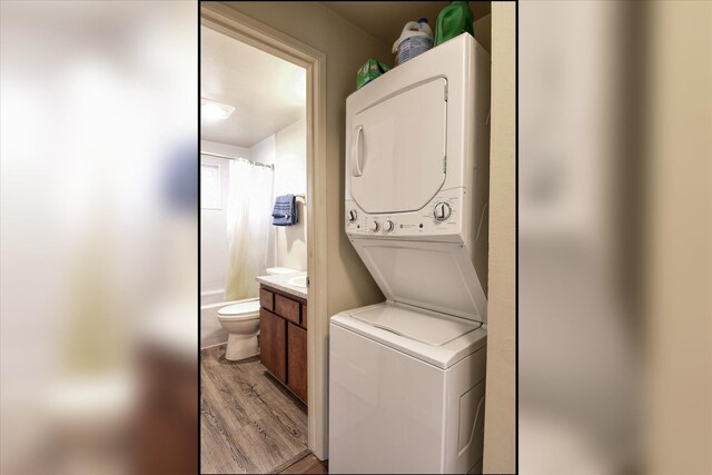 4718 N Campbell Rd, Otis Orchards, WA 99027 - clothes washing area featuring stacked washer / drying machine and light wood-style floors