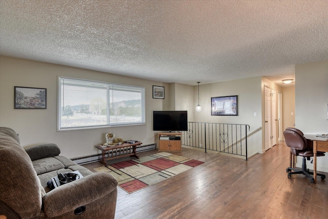 4718 N Campbell Rd, Otis Orchards, WA 99027 - living area with a baseboard heating unit, wood-type flooring, and a textured ceiling