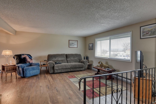 4718 N Campbell Rd, Otis Orchards, WA 99027 - living room featuring wood-type flooring, a textured ceiling, and a baseboard radiator