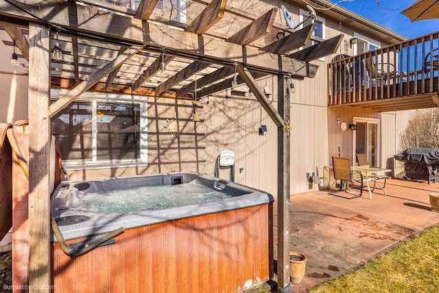 view of patio featuring a hot tub and a pergola