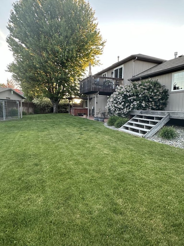 view of yard with fence and a deck