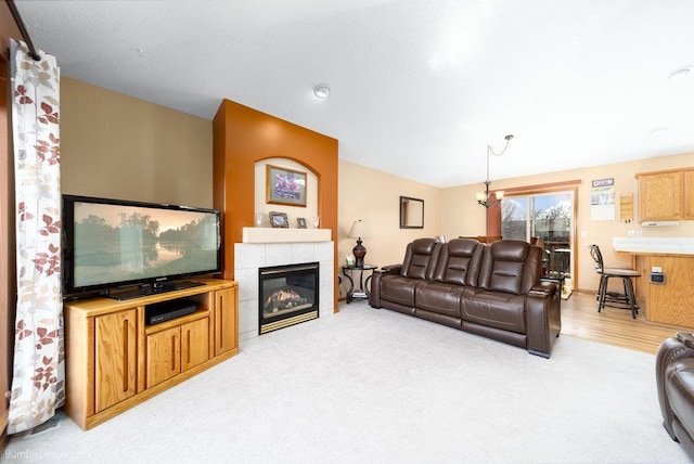 living area featuring a fireplace, lofted ceiling, and light carpet