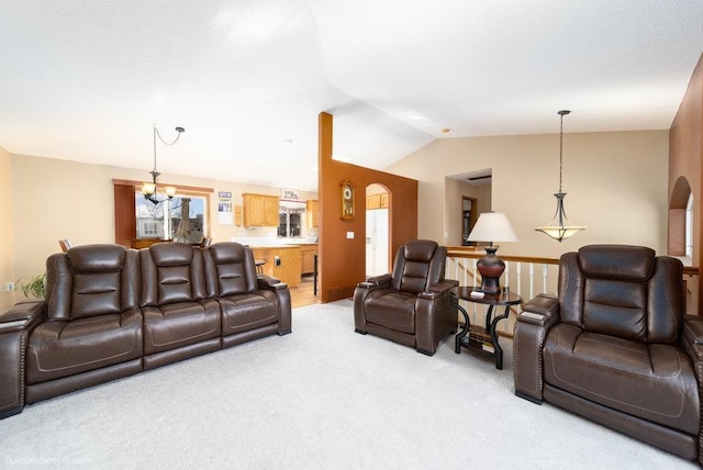living room with light colored carpet, lofted ceiling, arched walkways, and a chandelier