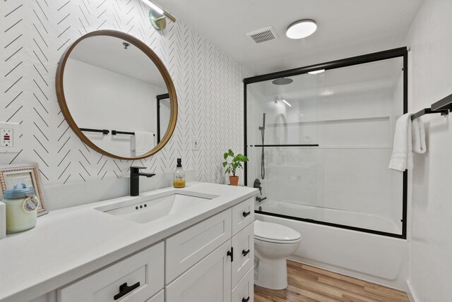 14505 W Coulee Hite Rd, Spokane, WA 99224 - bathroom featuring toilet, vanity, wood finished floors, visible vents, and wallpapered walls