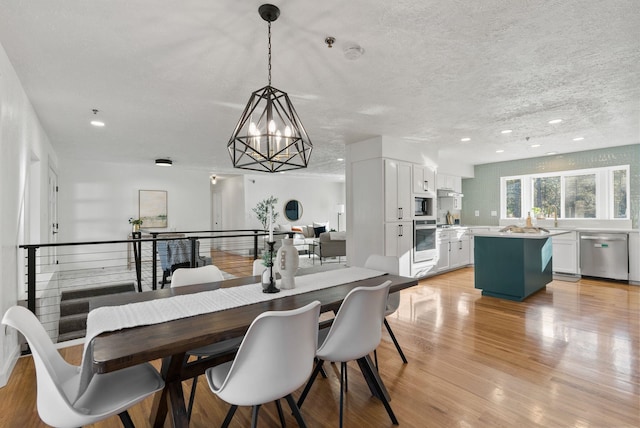 14505 W Coulee Hite Rd, Spokane, WA 99224 - dining space featuring a textured ceiling, a chandelier, recessed lighting, and light wood finished floors