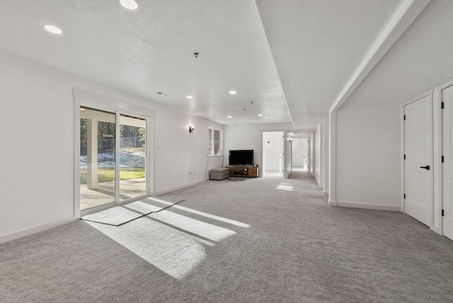 14505 W Coulee Hite Rd, Spokane, WA 99224 - unfurnished living room featuring baseboards, carpet floors, and recessed lighting