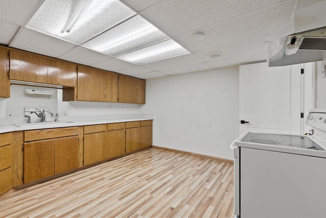 14505 W Coulee Hite Rd, Spokane, WA 99224 - kitchen featuring light countertops, white range with electric stovetop, a sink, light wood finished floors, and brown cabinets