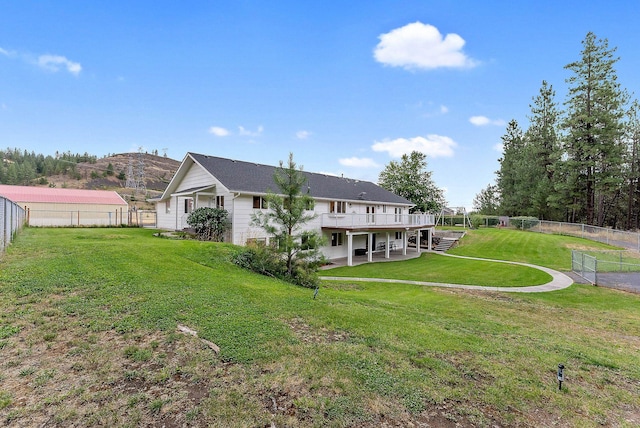 14505 W Coulee Hite Rd, Spokane, WA 99224 - back of property featuring a lawn, a wooden deck, and a fenced backyard