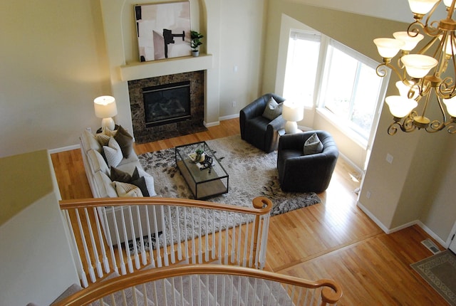 612 N Madson Ct, Liberty Lake, WA 99019 - living area with baseboards, wood finished floors, an inviting chandelier, and a tile fireplace
