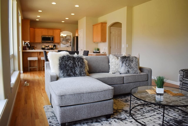 612 N Madson Ct, Liberty Lake, WA 99019 - living room featuring recessed lighting, arched walkways, and light wood-type flooring