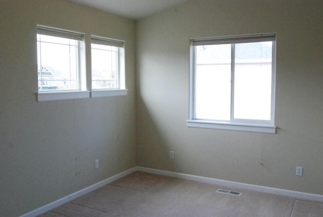 612 N Madson Ct, Liberty Lake, WA 99019 - unfurnished room with baseboards, visible vents, light colored carpet, and lofted ceiling