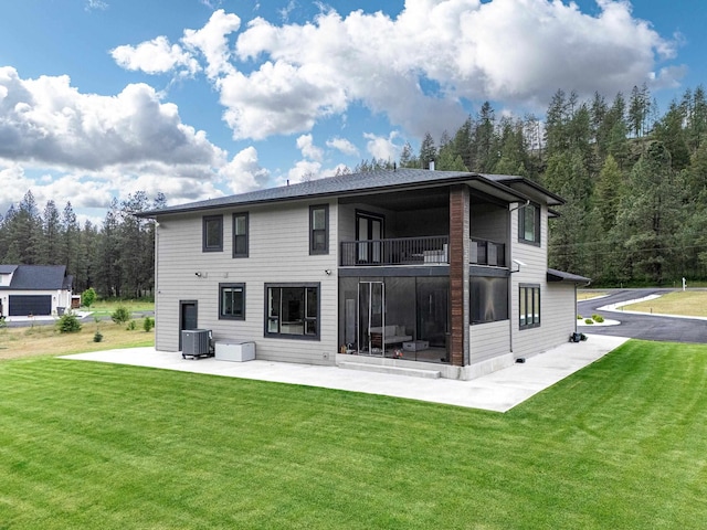 16215 W Coulee Hite Rd, Spokane, WA 99224 - back of property with a balcony, a patio, a lawn, and central AC unit