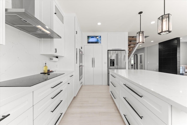 16215 W Coulee Hite Rd, Spokane, WA 99224 - kitchen with wall chimney exhaust hood, stainless steel appliances, recessed lighting, white cabinetry, and light stone counters