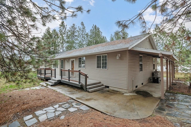 12716 N Yale Rd, Mead, WA 99021 - view of front of home featuring a wooden deck, roof with shingles, and a patio area