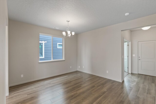 503 N Arc Ct, Spokane Valley, WA 99016 - spare room with a chandelier, wood finished floors, and a textured ceiling