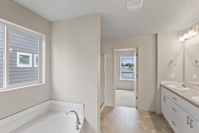 503 N Arc Ct, Spokane Valley, WA 99016 - bathroom featuring double vanity, a bath, and a shower with door