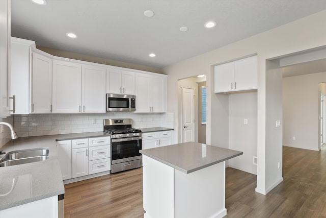 503 N Arc Ct, Spokane Valley, WA 99016 - kitchen featuring stainless steel appliances, decorative backsplash, wood finished floors, white cabinets, and recessed lighting