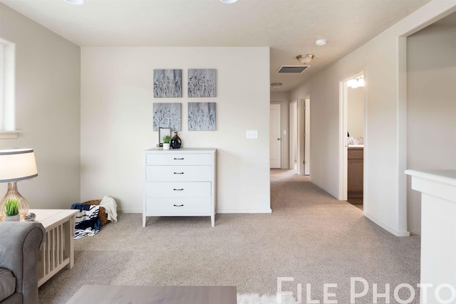 interior space with carpet floors, baseboards, and visible vents