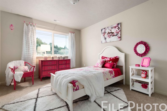 bedroom with baseboards, visible vents, and carpet floors