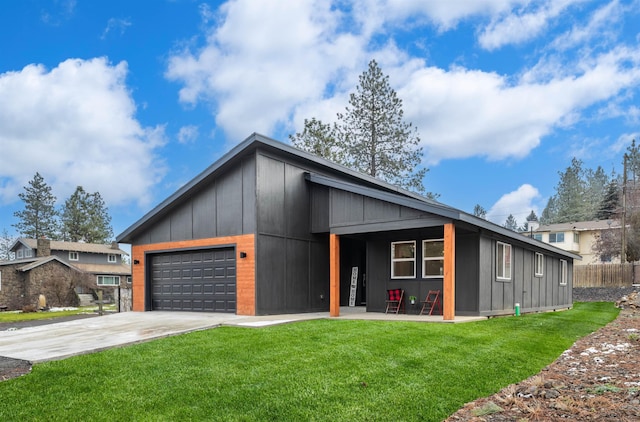 view of front of home with fence, a garage, concrete driveway, a front yard, and board and batten siding