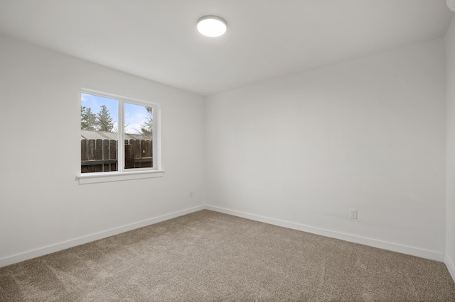 carpeted spare room with baseboards