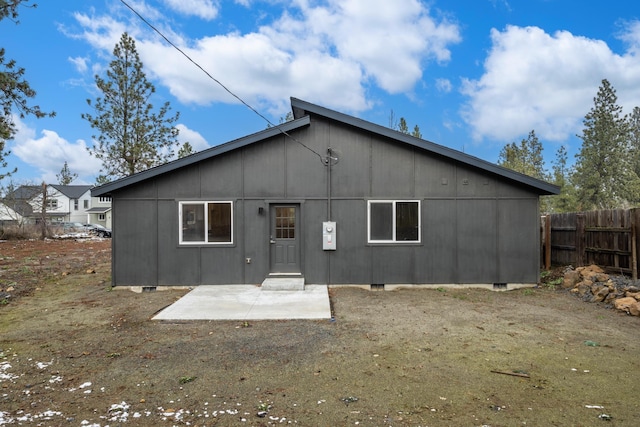 back of property featuring fence and a patio area
