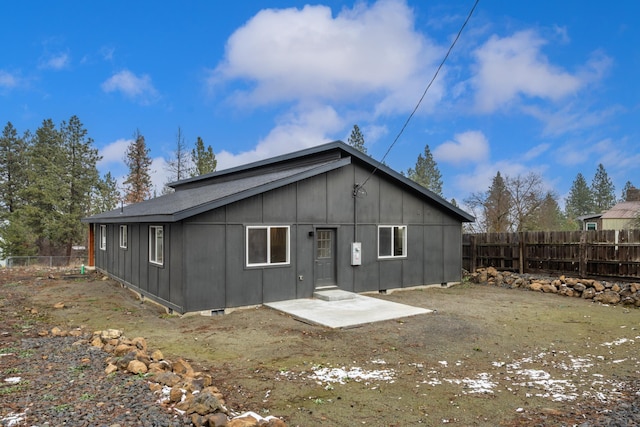 rear view of property with fence and a patio