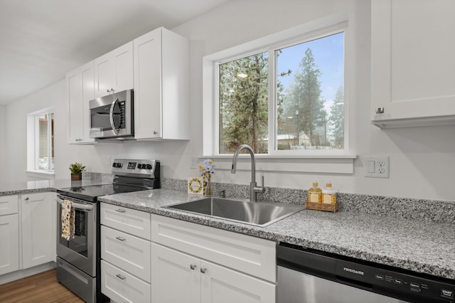 kitchen with white cabinetry, a sink, and stainless steel appliances