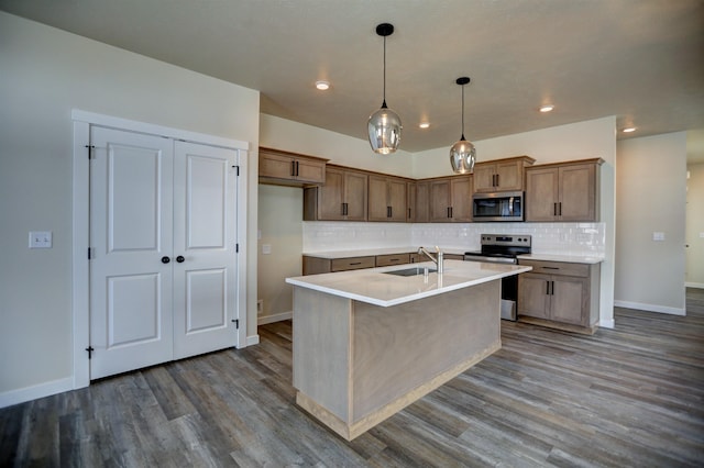 18517 E Michielli Ln, Spokane Valley, WA 99016 - kitchen with stainless steel appliances, a sink, decorative backsplash, dark wood-style flooring, and baseboards