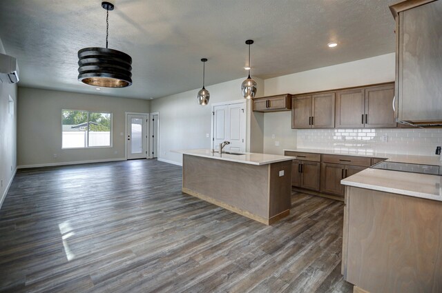 18517 E Michielli Ln, Spokane Valley, WA 99016 - kitchen featuring baseboards, tasteful backsplash, a sink, dark wood-style floors, and open floor plan