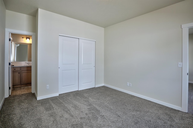 18517 E Michielli Ln, Spokane Valley, WA 99016 - unfurnished bedroom featuring dark colored carpet, baseboards, a closet, and a sink