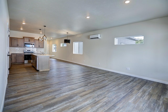 18517 E Michielli Ln, Spokane Valley, WA 99016 - kitchen with stainless steel appliances, a wall mounted AC, open floor plan, recessed lighting, and light countertops