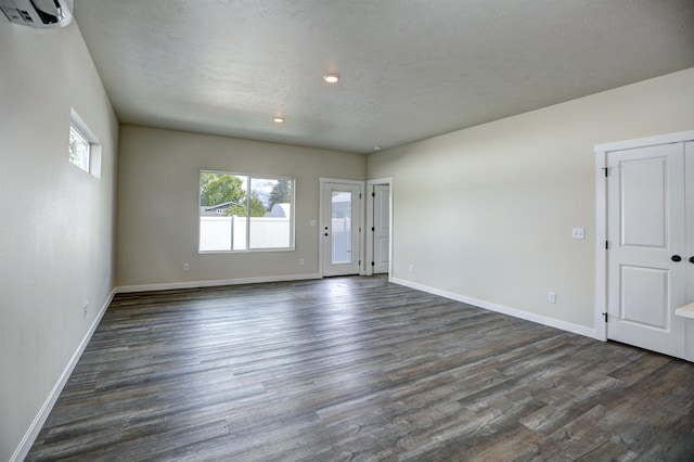 18517 E Michielli Ln, Spokane Valley, WA 99016 - spare room featuring dark wood-type flooring, a wall unit AC, baseboards, and recessed lighting