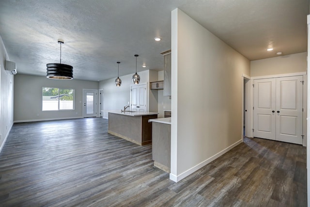 18517 E Michielli Ln, Spokane Valley, WA 99016 - kitchen with dark wood-style flooring, baseboards, light countertops, a wall mounted AC, and recessed lighting