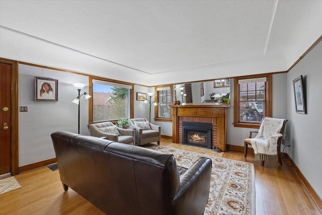 127 W 25th Ave, Spokane, WA 99203 - living room featuring baseboards, light wood-type flooring, visible vents, and a fireplace