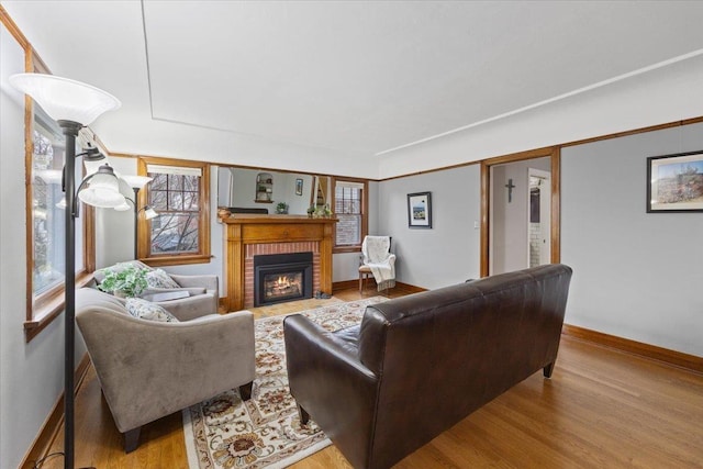 127 W 25th Ave, Spokane, WA 99203 - living room featuring baseboards, a fireplace, and wood finished floors