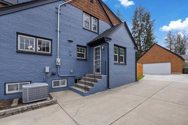 127 W 25th Ave, Spokane, WA 99203 - exterior space with cooling unit, a detached garage, an outdoor structure, and entry steps