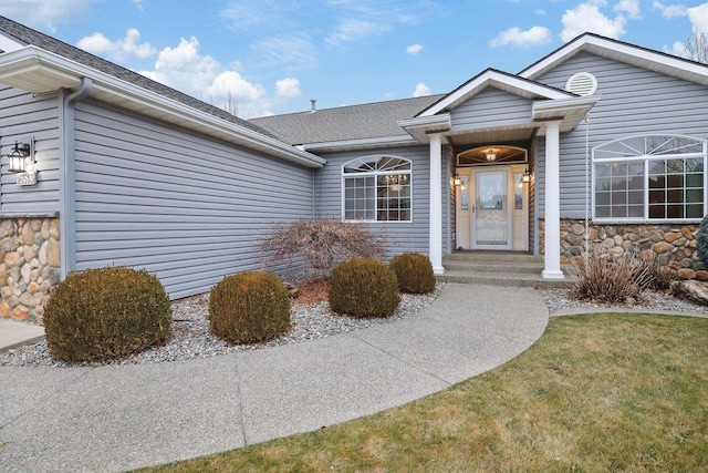 entrance to property with stone siding