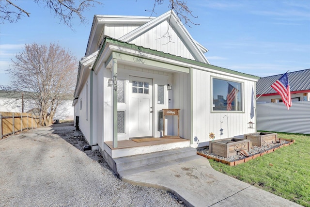 404 N Washington Ave, Newport, WA 99156 - view of front of home with board and batten siding, fence, and metal roof