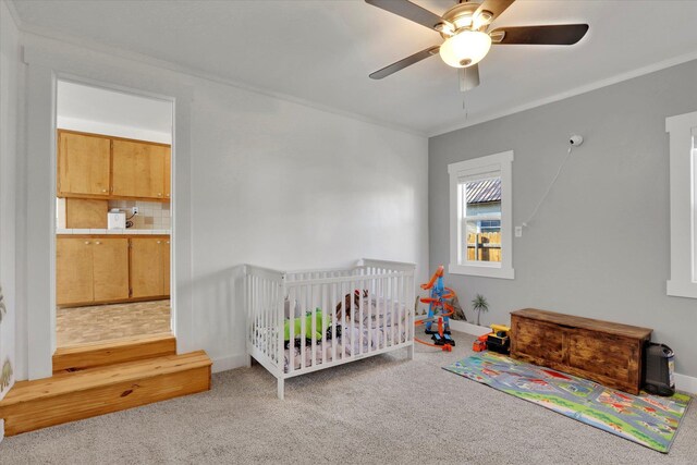 404 N Washington Ave, Newport, WA 99156 - carpeted bedroom with a ceiling fan, a crib, crown molding, and baseboards