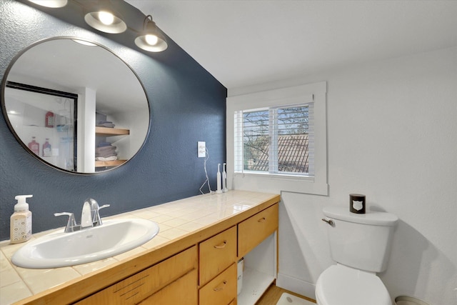 404 N Washington Ave, Newport, WA 99156 - bathroom with toilet, vanity, and a textured wall