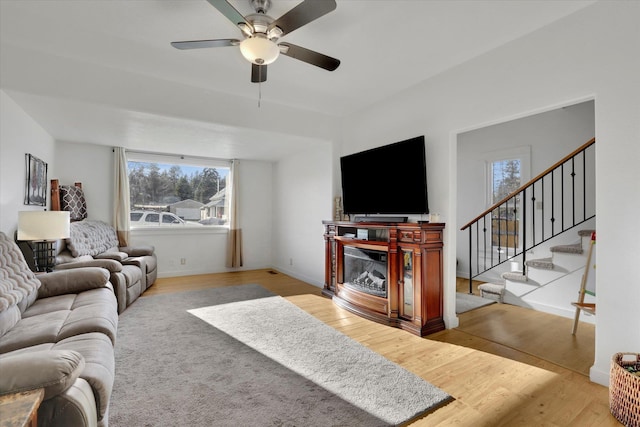 404 N Washington Ave, Newport, WA 99156 - living area featuring baseboards, stairs, ceiling fan, and wood finished floors