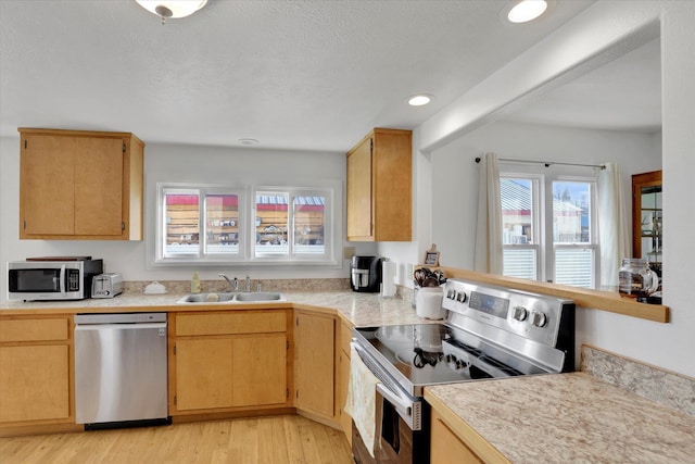 404 N Washington Ave, Newport, WA 99156 - kitchen featuring a textured ceiling, light wood finished floors, recessed lighting, appliances with stainless steel finishes, and a sink