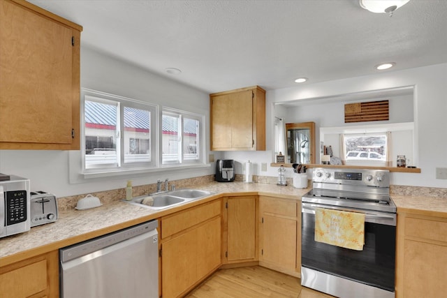 404 N Washington Ave, Newport, WA 99156 - kitchen with light wood-type flooring, light countertops, a sink, and stainless steel appliances