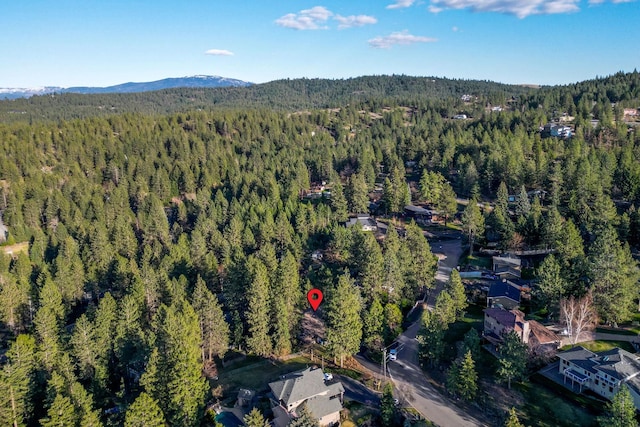 aerial view with a wooded view and a mountain view
