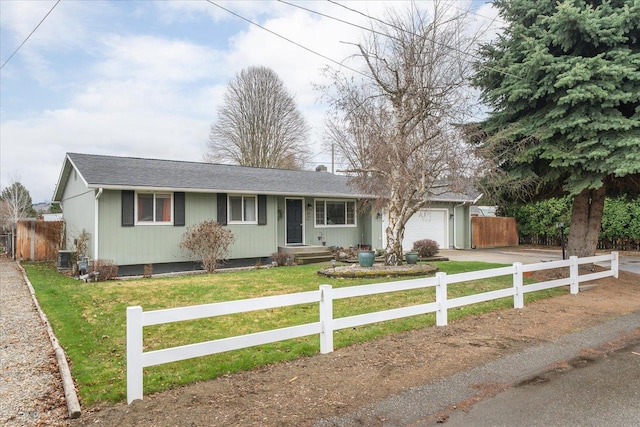 ranch-style home featuring an attached garage, fence, a front lawn, and concrete driveway