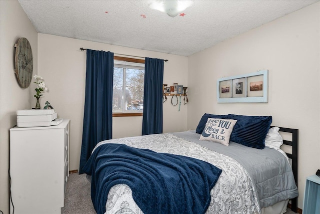 bedroom with a textured ceiling and carpet floors