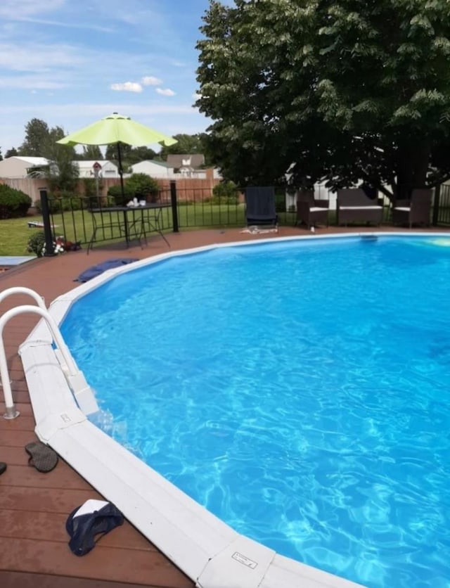 view of swimming pool featuring fence and a fenced in pool