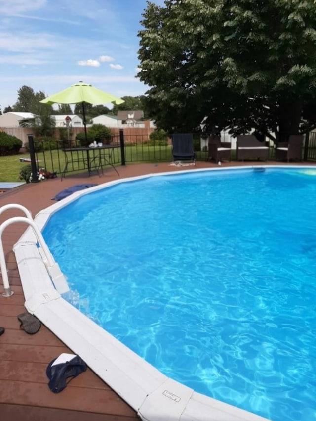 view of pool with a fenced in pool and fence